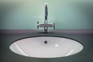 Bathroom sink with faucet dripping.